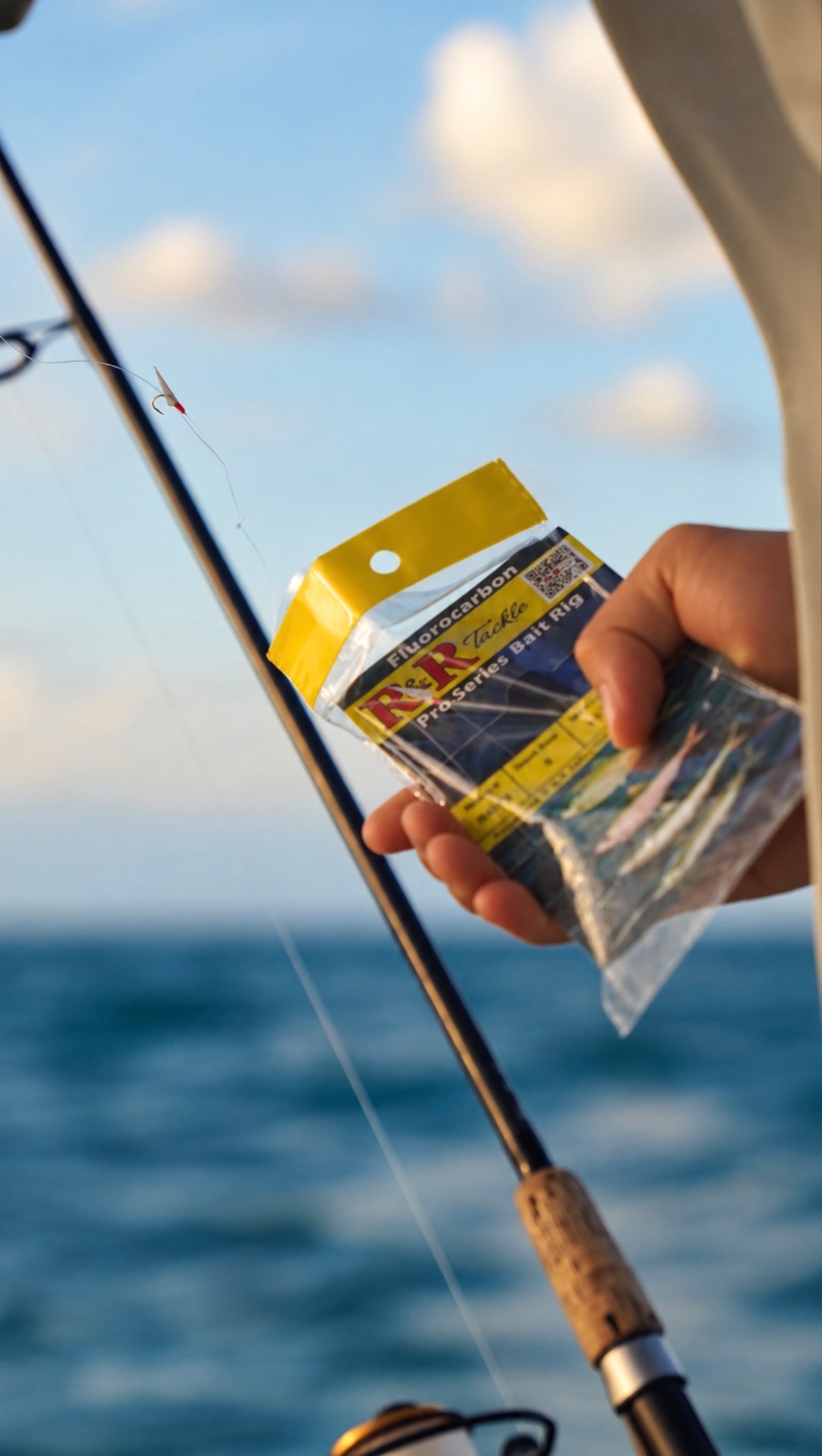 Angler holding an R&R Tackle Fluorocarbon Pro Series Bait Rig package beside a fishing rod, with a rigged hook visible.